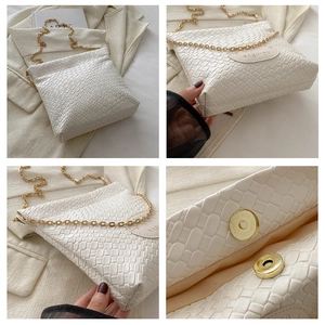 Detail view of white woven leather bucket bag with gold chain and magnetic buckle