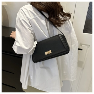 Rear view of a black minimalist rectangular shoulder bag with golden metal buckle clasp