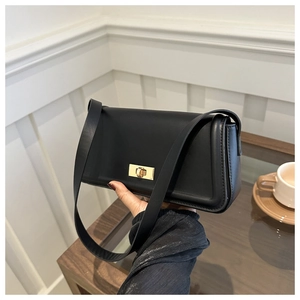 Minimalist black rectangle leather handbag with gold metal twist lock and wide shoulder strap