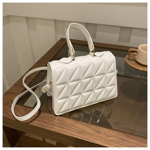 Elegant white quilted crossbody bag with triangular geometric patterns and gold hardware
