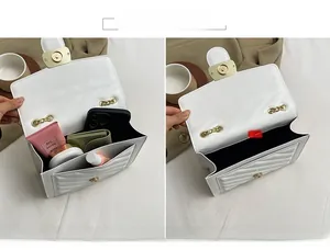 Detail showing high-capacity interior of white quilted chain bag with various items
