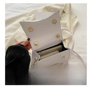 Interior view of white crocodile pattern crossbody bag showing storage capacity