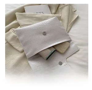 Interior capacity detail of the white crocodile texture clutch with a magnetic buckle