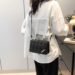 Quilted black crossbody bag with silver arch handle and chain strap for women