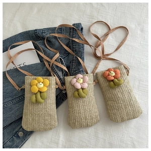 Handmade straw crossbody phone bag with 3D plush smile flowers in a bohemian summer style