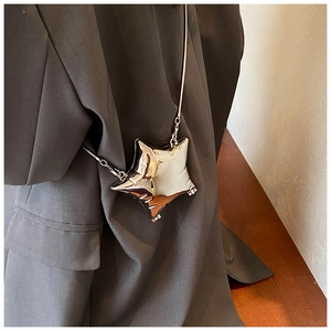 Detailed view of silver star-shaped mini crossbody bag with a sleek snake bone chain strap