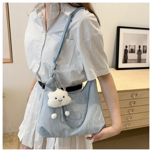 Light blue large tote bag with metallic chain and white cloud plush charm detail