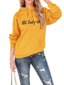 Detail of Old Lady-ish yellow hoodie paired with blue distressed denim jeans