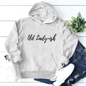 Flat lay of light grey hoodie with Old Lady-ish text on white wooden floor