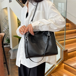 Minimalist black geometric patchwork tote bag with silver ring hardware for women