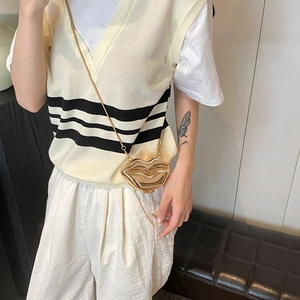 Stylish gold lip-shaped mini crossbody bag with sleek metal chain and mirror finish