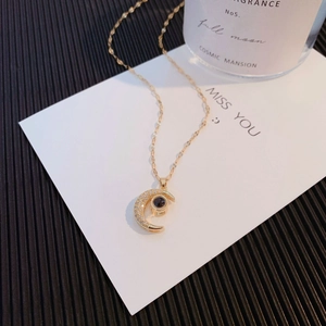 Elegant gold crescent moon projection necklace with micro-pave cubic zirconia crystals