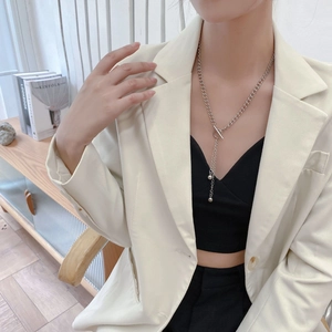Titanium steel bead tassel necklace with OT buckle worn by a model in casual attire