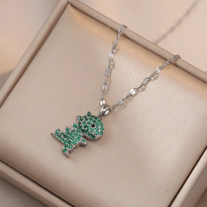 Titanium steel necklace with green zircon dinosaur pendant on a silk jewelry box