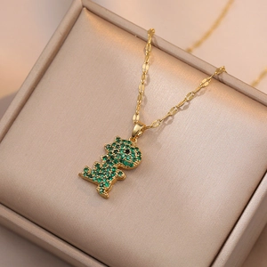 Titanium dinosaur pendant necklace with emerald green zircons on gold chain display