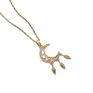Gold moon dreamcatcher necklace with sparkling crystals and three leaf charms on white