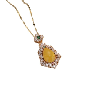 Women's gold necklace featuring a lemon yellow chalcedony teardrop pendant with zircons