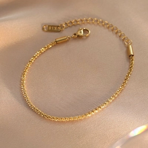 Minimalist K18 gold plated stainless steel twist chain bracelet on elegant silk fabric