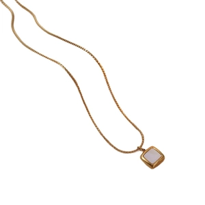 Minimalist gold titanium necklace with a square white shell pendant on a white backdrop