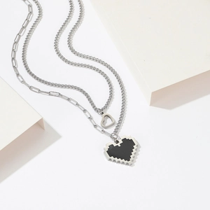 Close-up of double-layered titanium steel necklace with a black pixel heart pendant