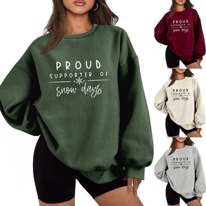 Detail of the crewneck sweatshirt featuring snow days print and soft plush texture