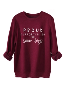 Detail of burgundy fleece sweatshirt featuring white snow days print and soft ribbed cuffs