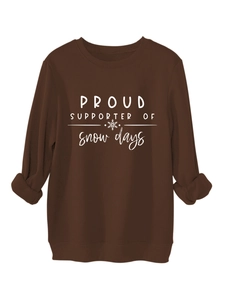 Detailed close-up of dark brown sweatshirt fabric and white snow days printed slogan