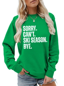 Detail of bright green crewneck sweatshirt with Sorry Can't Ski Season white text print