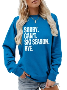 Blue crewneck sweatshirt detail showing SORRY CAN'T SKI SEASON white text print