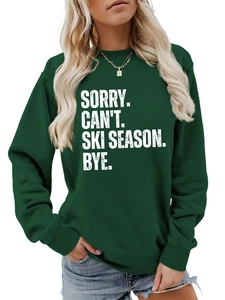 Detailed view of dark green loose sweatshirt featuring white 'SORRY CAN'T SKI SEASON' print