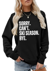 Close-up of black crewneck sweatshirt with Sorry Can't Ski Season slogan and ribbed cuffs