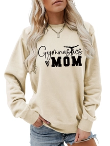 Detail of Gymnastics MOM print on a beige long-sleeve sweatshirt with a heart graphic