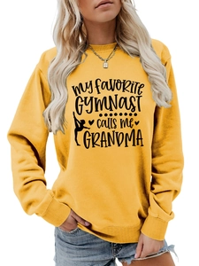 Close-up of yellow sweatshirt with My Favorite Gymnast calls me Grandma text print