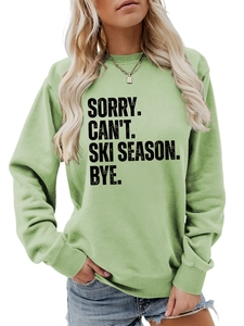 Close-up of ribbed neckline and Sorry Can't Ski Season slogan on green sweatshirt