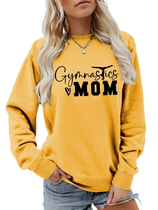 Detail of Gymnastics Mom text and silhouette print on ginger yellow sweatshirt fabric