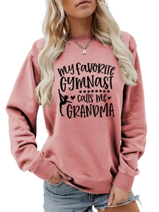 Detail of pink crewneck sweatshirt with My Favorite Gymnast Calls Me Grandma print