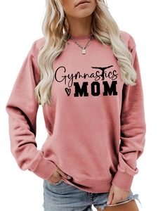 Detailed close-up of Gymnastics Mom text and silhouette print on pink sweatshirt