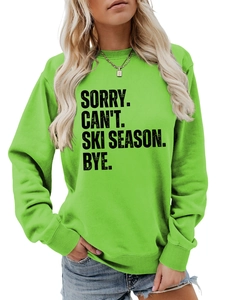 Detail of neon green crewneck sweatshirt with SORRY CAN'T SKI SEASON black letter print