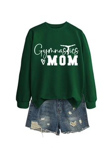 Flat lay of a green Gymnastics MOM sweatshirt paired with frayed denim shorts