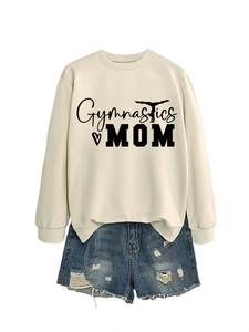 Detail of beige gymnastics mom sweatshirt paired with distressed blue denim shorts