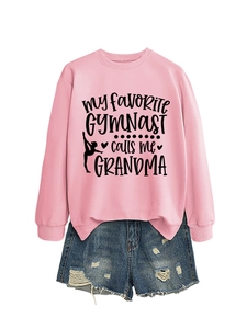 Flat lay of pink sweatshirt with gymnast print and distressed blue denim shorts set