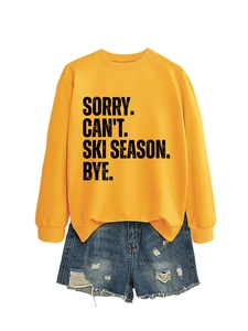 Detail of yellow cotton sweatshirt with black Ski Season print and blue ripped denim shorts