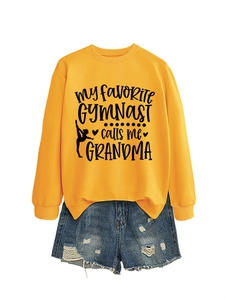 Flat lay of an orange gymnast sweatshirt with denim shorts on a white background