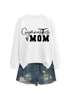 Flat lay of Gymnastics MOM white sweatshirt paired with distressed denim shorts