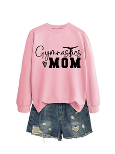 Flat lay of pink Gymnastics MOM sweatshirt paired with distressed denim shorts