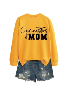 Detailed view of yellow Gymnastics MOM sweatshirt paired with distressed blue denim shorts