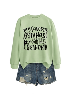 Detail of mint green sweatshirt with 'MY FAVORITE GYMNAST calls me GRANDMA' print design