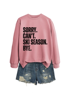 Flat lay of pink hoodie with Sorry Can't Ski Season text and frayed denim shorts