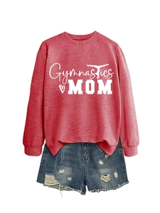 Flat lay of maroon Gymnastics Mom sweatshirt with distressed denim shorts on white background