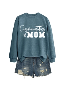 Flat lay of Gymnastics Mom blue sweatshirt and ripped denim shorts on white background